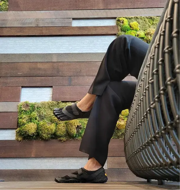 Radhika Dutt walking barefoot as a symbol of grounded leadership
